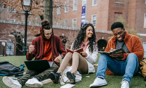 new research shows that a GEAR Up Program led to a 48% increase in college completion A group of three smiling college students. Tow men and one woman